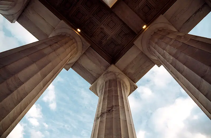 Upward view of tiled ceiling and pillars