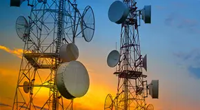 Two microwave towers at sunrise