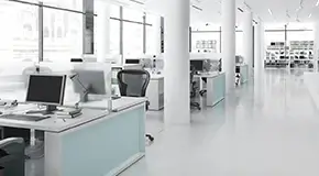 Sterile, white office space with large window panes in the background