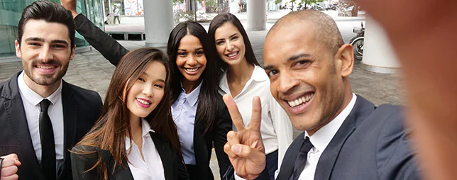 Young business people of different ethnic backgrounds dressed in suits.