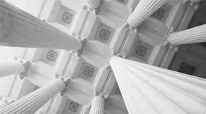 Upward view of white tiled ceiling and pillars