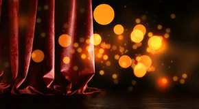 Magical lights floating through an open stage curtain