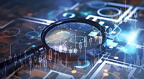 Magnifying glass on top of a computer screen with a report chart