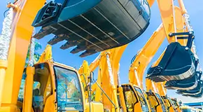Rows of yellow and black construction excavators