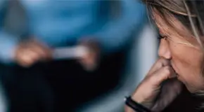 Woman both anxious and in deep thought during therapy