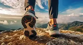 A man arriving on a mountain top