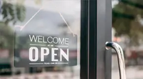 Close up shot of an open sign at an undisclosed retail space